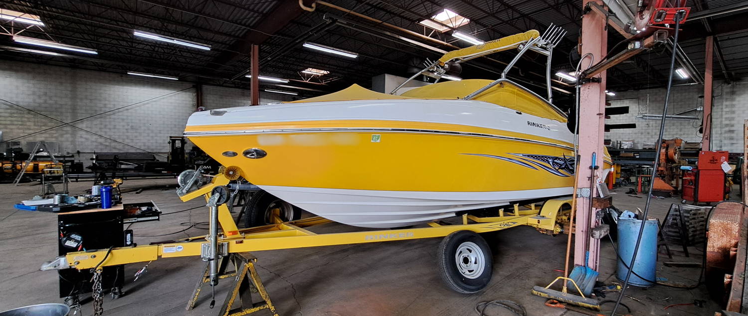 Rinker boat trailer in JTI Trailers' shop for routine maintenance