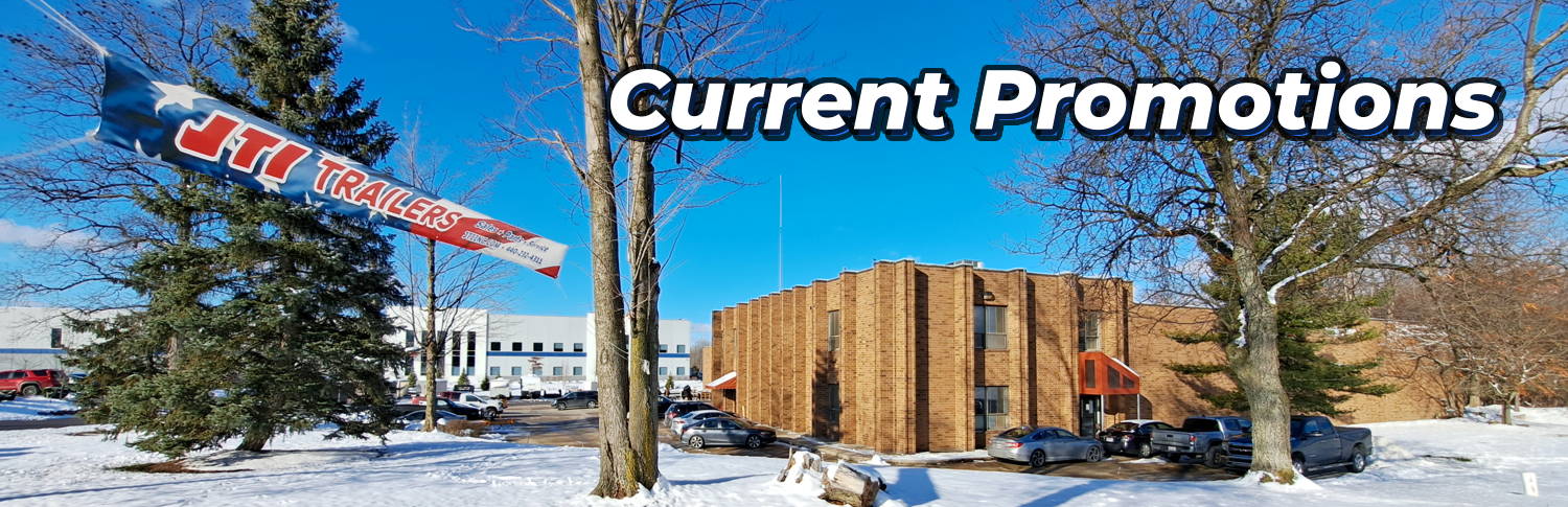 JTI Trailers exterior in December 2025 with JTI Banner hanging between trees