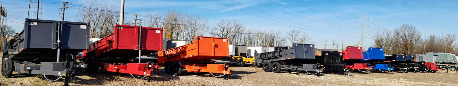 Line of Quality Steel and Aluminum Dump Trailers at JTI including grey red and orange dump trailers