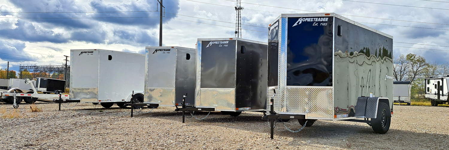 Four Homesteader Trailers Enclosed Cargo Trailers on the lot, JTI Trailers in Bedford, Ohio Fall 